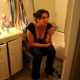 A very brief video clip of a girl smoking while pooping on the toilet. She quickly closes the door when she realizes that she is on camera.